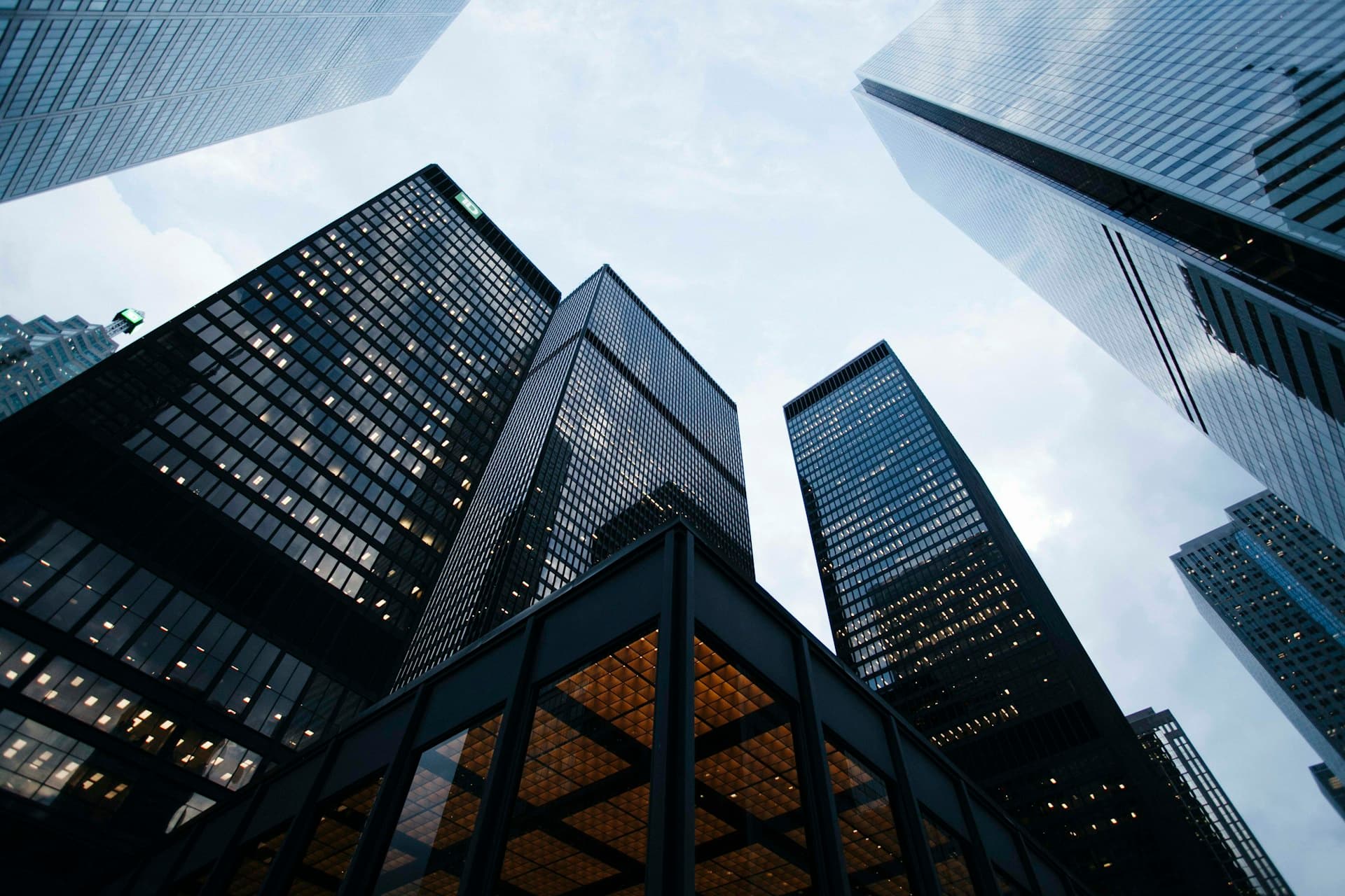 Modern glass office towers viewed looking upward against the sky